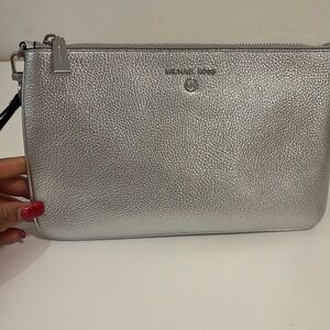 Michael Kors large metallic pebbled leather wristlet,gently used.
